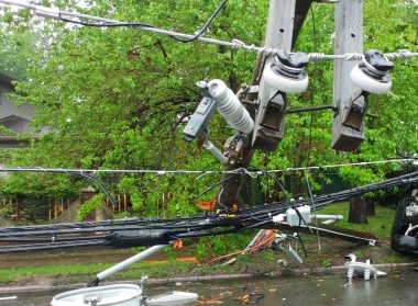 Storm damaged electric transformer on a pole and a tree damaged clipart