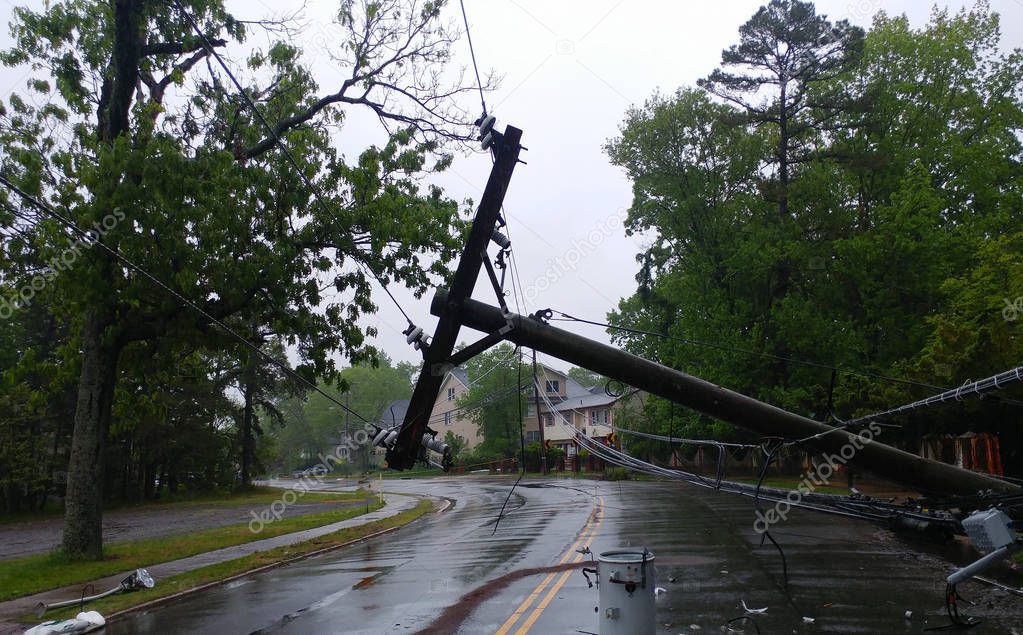 Storm damaged electric transformer on a pole and a tree damaged