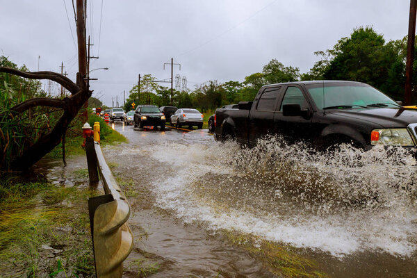 Flooded feeder street . Heavy rains from hurricane Harvey caused many flooded Splash by a car as it goes through flood water