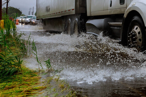 Vehicle road because of flooding car drives through flooded road