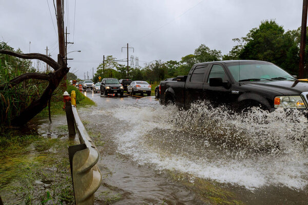 10 SEPTEMBER 2018 NJ USA: Flooded feeder street . Heavy rains from hurricane Harvey caused many flooded Splash by a car as it goes through flood water