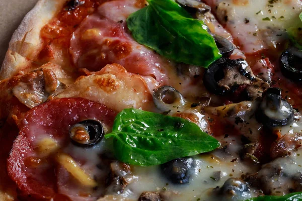 Pizza in a cardboard box Food ingredients and spices for cooking mushrooms, tomatoes, cheese, onion, oil, pepper, salt, basil, olive and delicious italian pizza