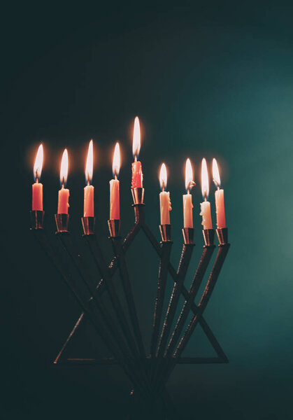 Candle lite on the traditional Silver menorah Hanukkah Jewish holiday