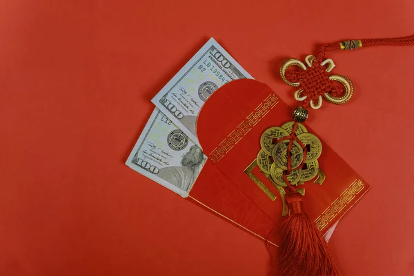 Money in red envelopes Chinese new year greeting gift, closed up of US dollar banknotes red traditional envelopes