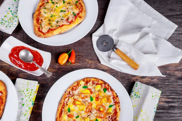 Italian Pizza Dinner Restaurant Menu - Margarita and Salmon pizzas served on wooden table Top View