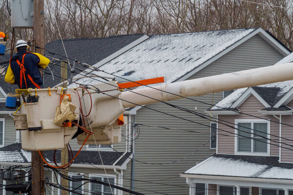 Repairing power lines after on them in snow storm damage, electricity