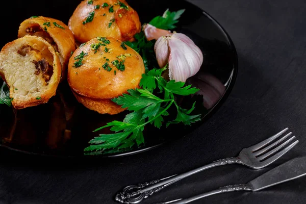 Mushrooms and meat buns with garlic, cheese and herb butter a wooden board in the background