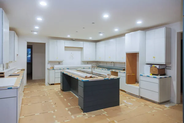 Interior design construction of kitchen with cabinet maker installing custom