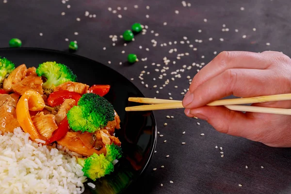 Pieces of chicken fillet with teriyaki sauce on topped rice bowl