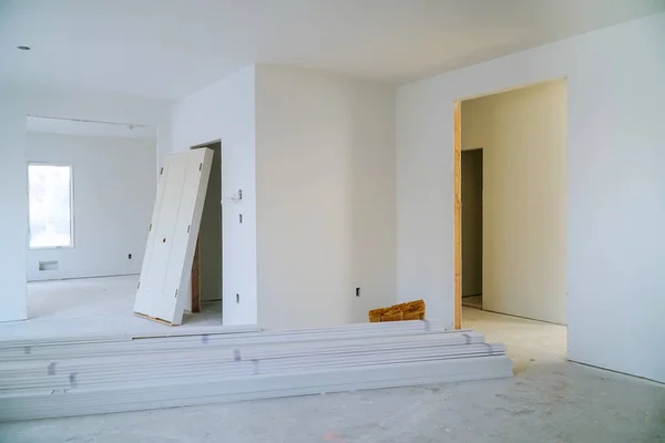 Interior construction of housing project with door and molding installed