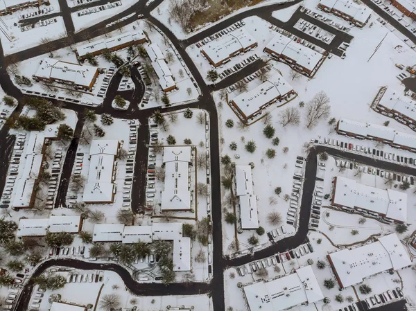 Paesaggio dall'alto della strada della città con case edifici innevati, un cielo grigio nuvoloso . — Foto Stock