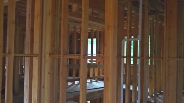 Residential Home Construction Site Framed Close Up a wide shot of a new home construction with some framed wall up — Stock Video