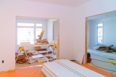 Interior construction of housing project with door and molding installed clipart