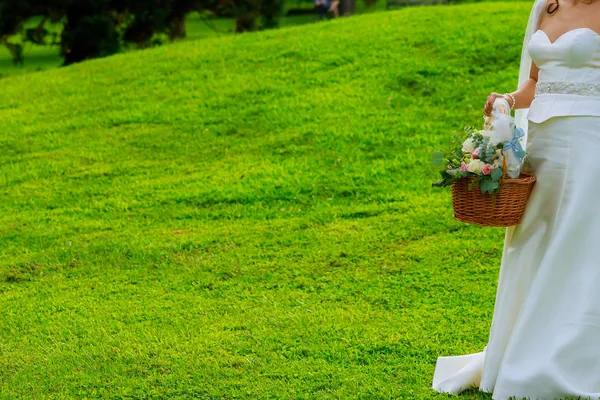 Bruiloft meisje houdt een mand van bloemblaadjes. — Stockfoto