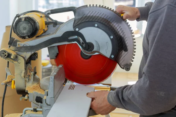 Carpintero trabajando con sierra circular sierra giratoria cortando zócalo de madera — Foto de Stock