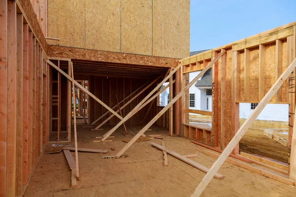 Wood framework of new residential home under construction. Royalty Free Stock Images