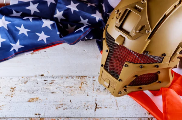 Military helmets and American flag on Veterans or Memorial day