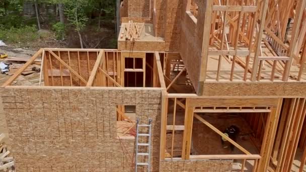 Building construction, wood framing structure at new property development site — Stock Footage Building construction, wood framing structure at new property development site Royalty Free Stock Video