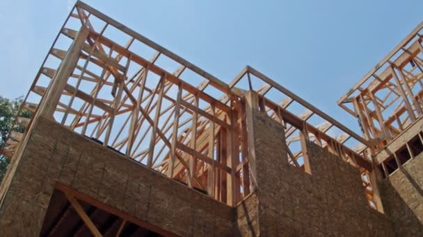 Framing structure wood frame of wooden houses home close-up new stick built home under construction under — Stock Footage Framing structure wood frame of wooden houses home close-up new stick built home under construction under Royalty Free Stock Footage