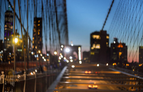 Blurred urban traffic Brooklyn Bridge at twilight in New York City scene at night