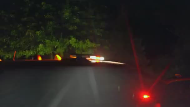 Night time scene with emergency vehicles and police lights flashing — Stock Video