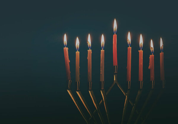 Hanukkah menorah with candles for chanukah celebrationon black background
