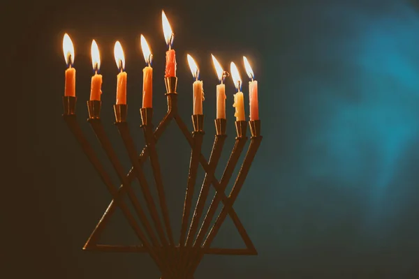 Menorah med färgglada ljus för Hanukkah på ljusblå bakgrund, närbild — Stockfoto