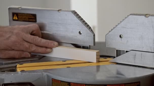 Worker cuts wood baseboard on the power miter saw — Stock Footage Worker cuts wood baseboard on the power miter saw Video Clip