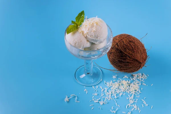 Coconut ice cream, three scoops in a glass bowl