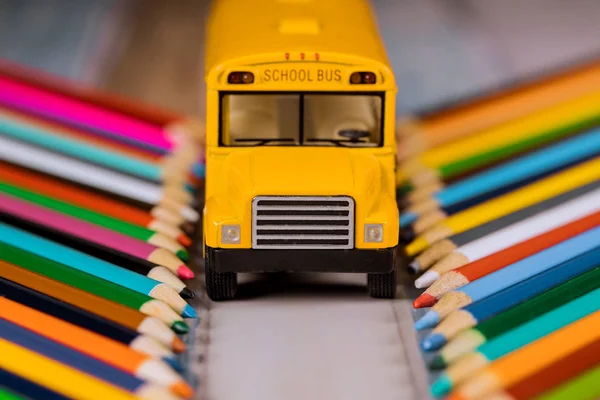 Colored pencils and yellow school bus, back to school.