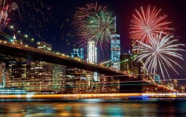 Colorful holiday fireworks panoramic view New York city Manhattan downtown skyline at night clipart