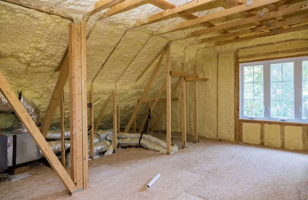 Schuimplastic isolatie geïnstalleerd in de hellende zolder van nieuw frame huis. — Stockfoto