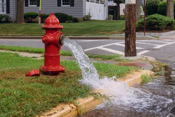 Leaking fire hydrant strong water flow — Stock Photo, Image