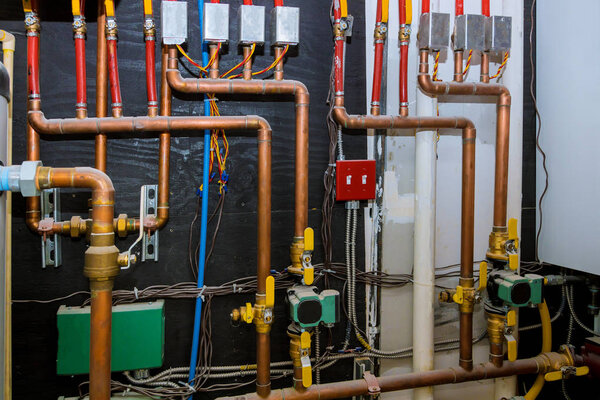 Heating system's copper pipes with ball valves on pipes collector of underfloor heating system