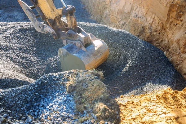 Industrial machinery construction site, excavator moving gravel and rocks for foundation building