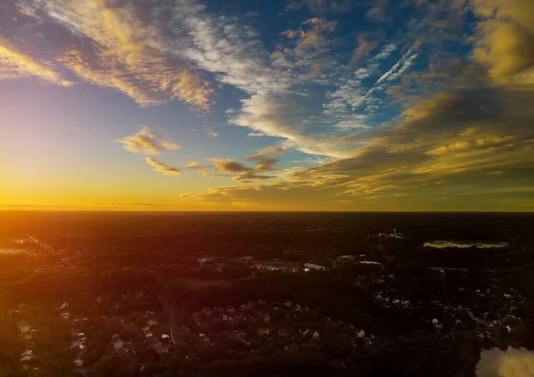 Aerial top down view flying over appartments in small town showing neighborhood early sunrise