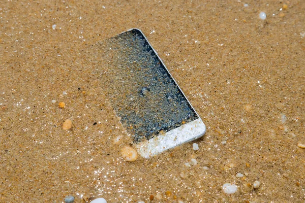 Lost mobile phone fall to the under the ocean water near the beach.