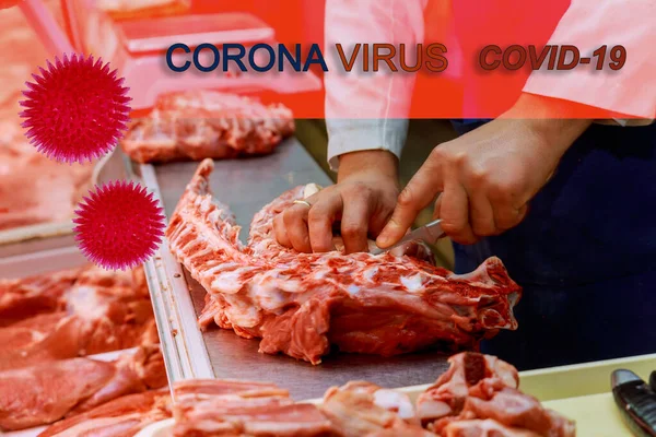 Closed raw meat market hands of a butcher cutting meat slices of with knife at counter in shop