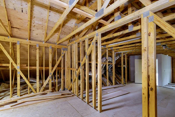 Unfinished roofing of interior view of a house residential construction wall of attic framing against