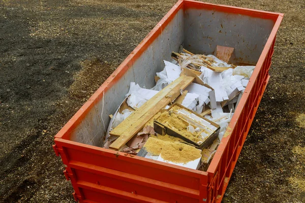 Construction trash dumpsters on metal container, house renovation.