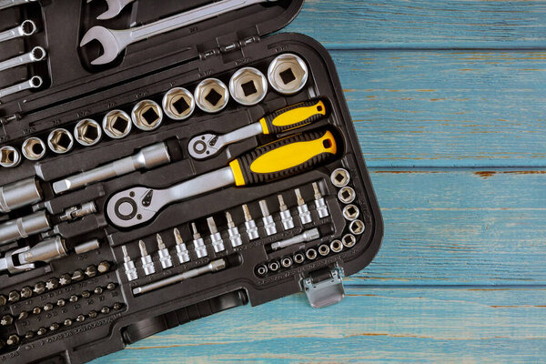 Auto mechanic tool kit professional car mechanic automotive set tool of wrenches chrome tools on wood background.