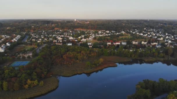 Vue aérienne des zones résidentielles le long de la rivière avec des maisons privées banc dans le paysage d'automne — Video