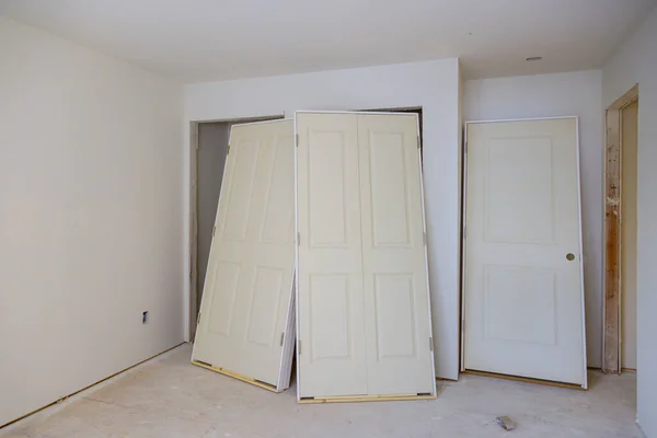 Interior wooden stacker door installation,apartment building, a wait installation for preparation of interior in new home