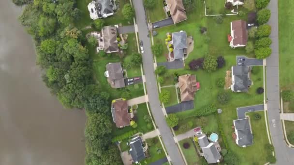 Amazing aerial view over the small town along river flowing between — Stock Video