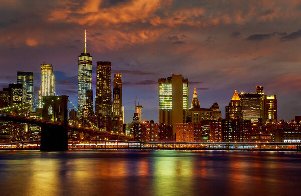 Gorgeous view of Brooklyn bridge at Manhattan skyline after sunset, New York City City illuminated at night