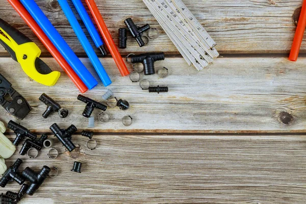 Various set of tools for the plumber on preparing master before work, polypropylene pipes, corners, fasteners, pipe cutting tools, fixings