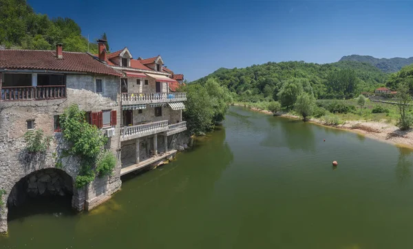 Stock image Skadar lake, Montenegro - 07.15.2018.  Panoramic view of the Old Bridge over Crnojevica river, Rijeka Crnojevica, and the tourist area near the bridge, Rijeka Crnojevica.