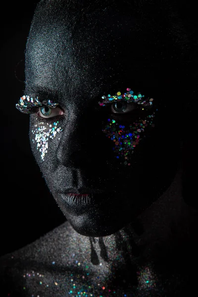 Girl in black makeup with sparkles