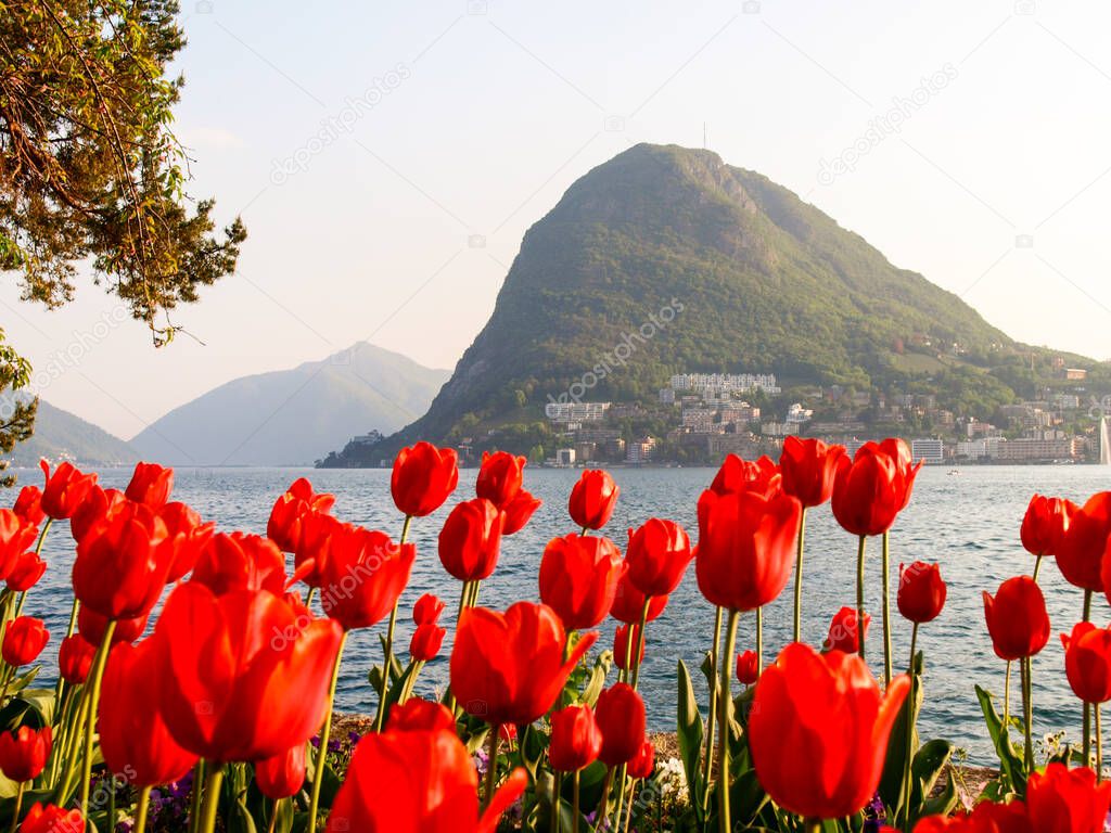 Lugano, Switzerland: Gulf of Lugano at sunset with many tourists for Easter.