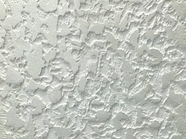 Beyaz duvarın, desenli macun alçılı arka plan desenini kapat